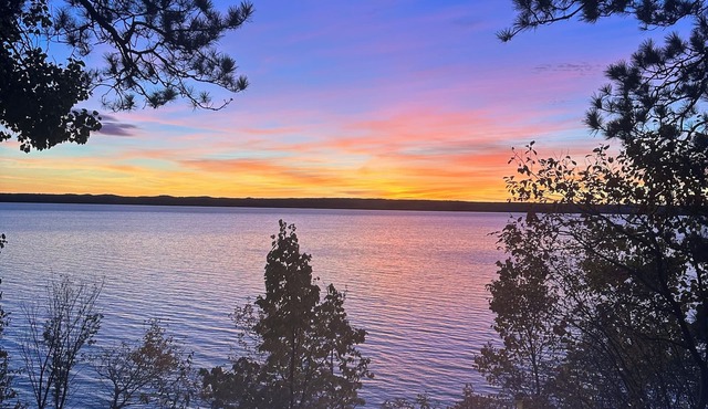 Cozy Hubbard Lake waterfront -beautiful views, private wooded lot, fireplace