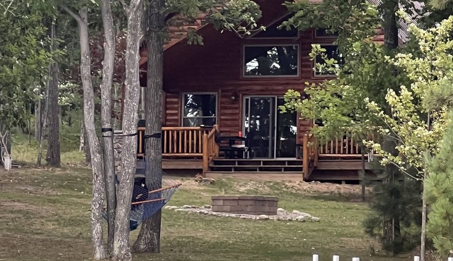 Cozy lake-front home on crystal clear, all sports Long Lake in Hillman, MI.