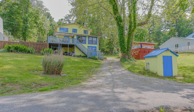 Cozy lakefront retreat with private dock, scenic views, updated interiors and serene outdoor seating