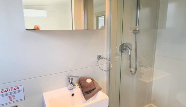 Cozy Matarangi Cabin. Enjoy the gardens and lake views from your private deck.