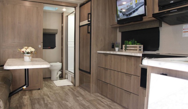 Cozy new trailer situated near restaurants and stores .