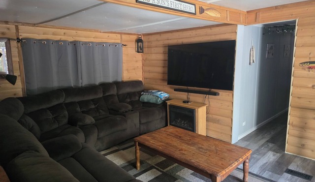 Cozy river cabin with hot tub, great fishing, and peaceful nature views.