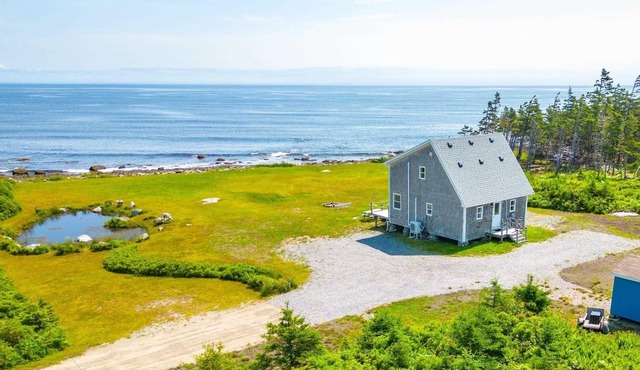 Cozy, tranquil waterfront retreat with a stunning oceanfront view in the pines.