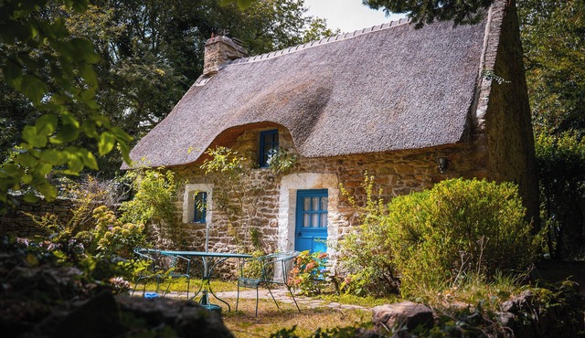 Cozy typical Breton chaumiere with thatched roof