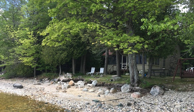 Cozy "up north" waterfront cottage. Fireplace. Short walk to town.