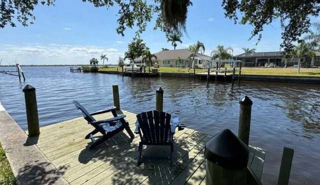 Cozy waterfront retreat with hot tub, deck, and firepit.