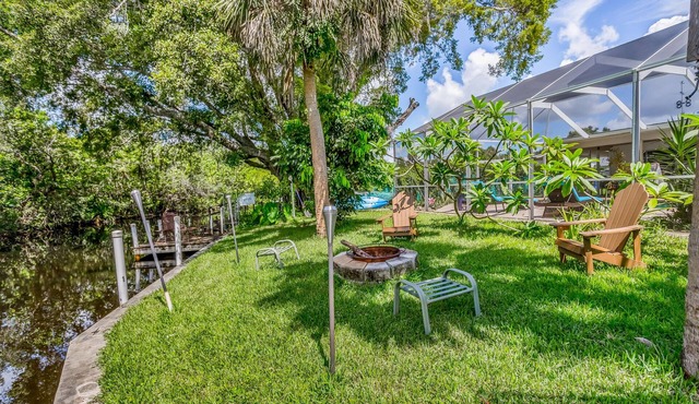 Creekside retreat with screened pool, patio, grill, firepit, canoe + kayak, & AC