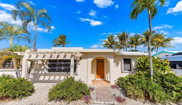 Custom canal-front home with private pool, palapa hut, & outdoor kitchen