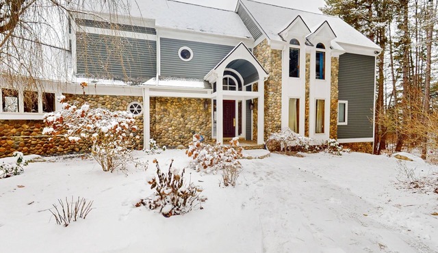 Custom dog-friendly home with private swimming area, fireplace, gym, grill, deck