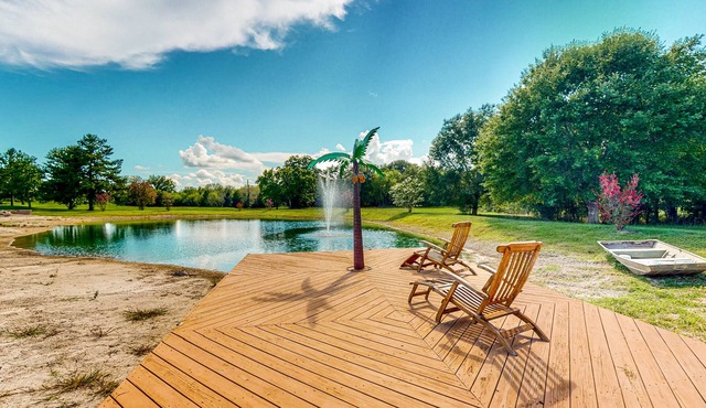 Custom home with guesthouse, pond, sunning deck, beach & tropical bar