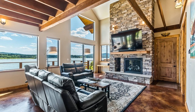 Custom riverfront home with private dock, game room, hot tub & heated floors