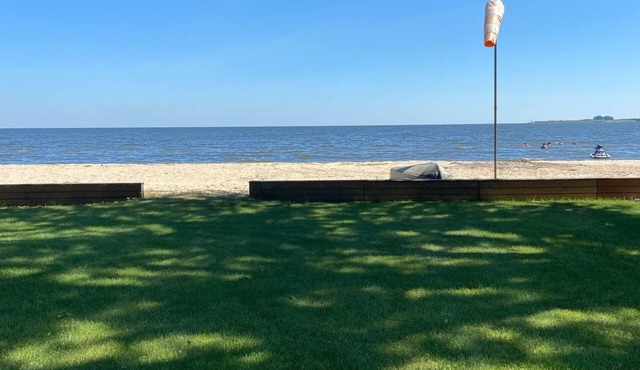 Cute house on Saginaw Bay with hot tub on private beach.