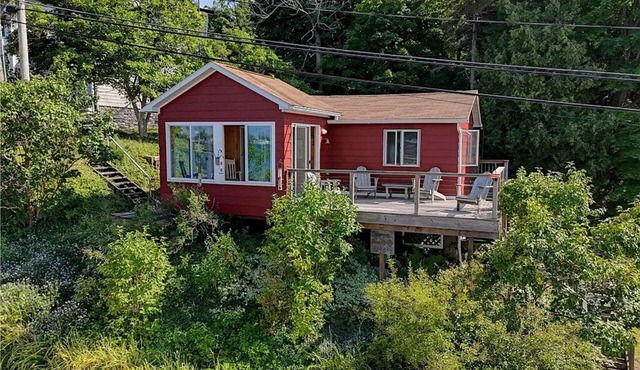 Cute red cottage on the hillside overlooking Sodus Bay. Direct water access