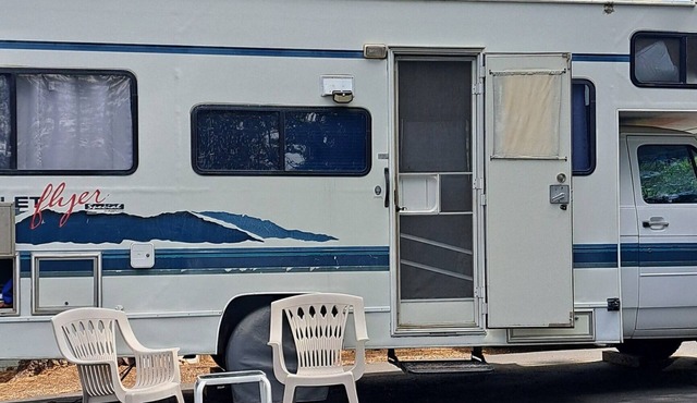 Cute RV in the forested mountains at Cedar Ridge, Sonora for your vacation.