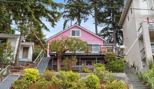 Darling pink beach house with epic views in a cozy community.