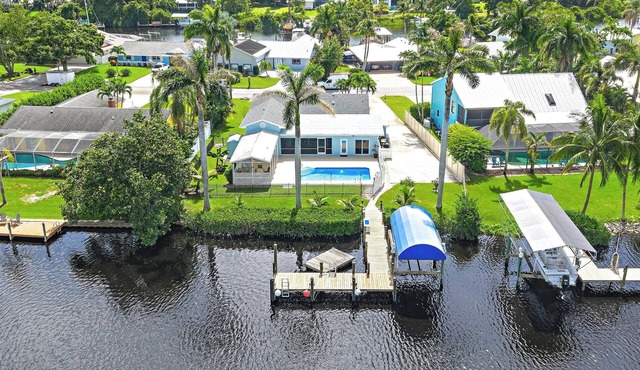 Deep water front home with private dock, pool, outdoor kitchen and pool table.