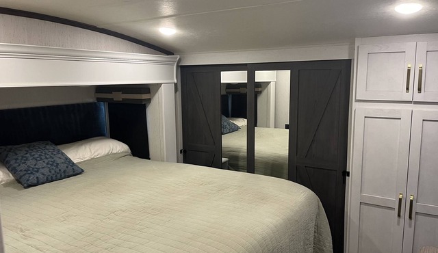 Deluxe 5th wheel in beautiful forest setting ready for you.