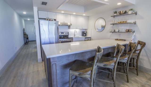 Designer Condo! Walk to the Beach! Bay Views! Rooftop Pool! Fully Renovated!