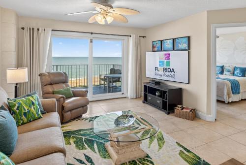 Direct oceanfront 2/2 condo with a private balcony, heated beachfront pool, and garage