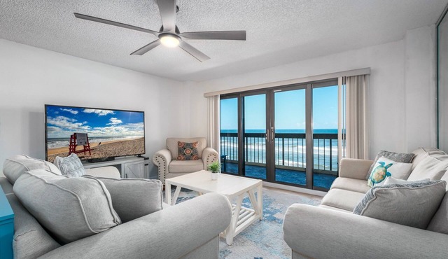 Direct oceanfront corner with private balcony, heated beachfront pool and garage parking