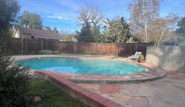Dog friendly cottage with porch, pool, massive yard, and plenty of parking.