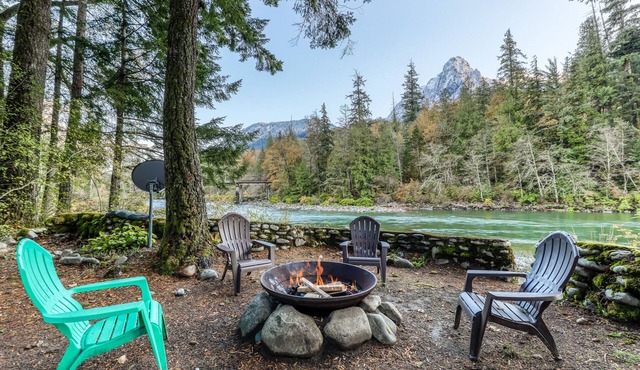 Dog-friendly cottage on the river with private hot tub, mountain views & firepit