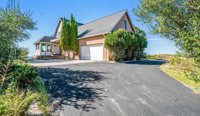 Dog-friendly, lake view home with three season room, fireplace, video projector