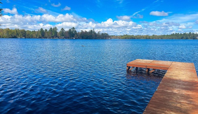 Dog-friendly lakefront property with dock, boat lift, firepit, & two kitchens