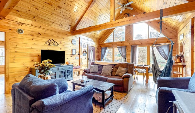Dog-friendly log cabin on 44 acres with woodstove & porch, near lakes/skiing
