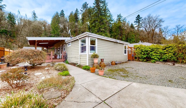 Dog-friendly riverfront home with patio, golf nearby, enclosed yard, & W/D