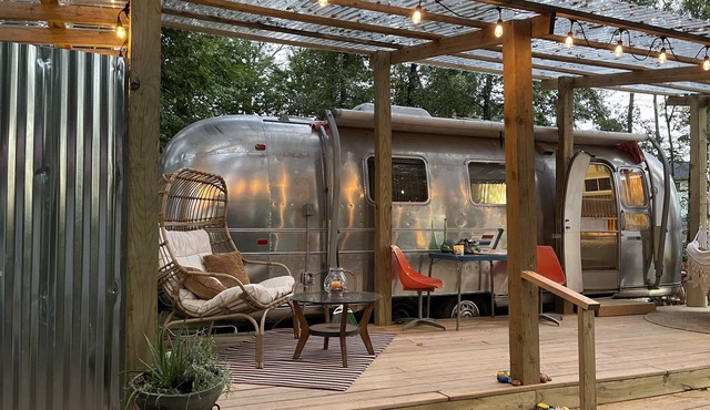 Dog-friendly vintage camper with grill, firepit, river access, & outdoor theater