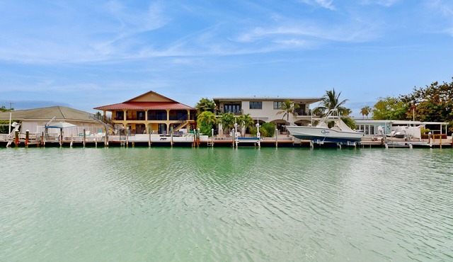 Dog-friendly waterfront home with dock, pool, gas grill, & beach access