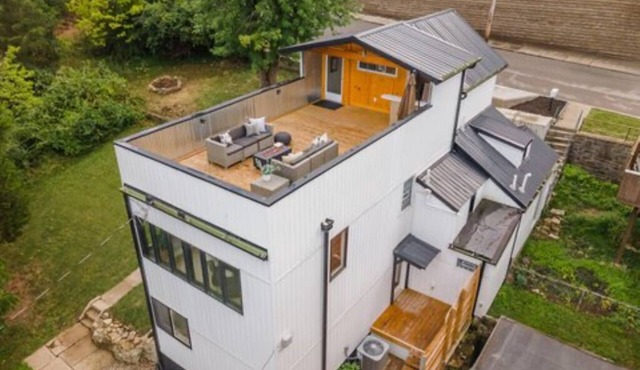 Downtown skyline view featuring giant rooftop deck & wet bar with a city view.