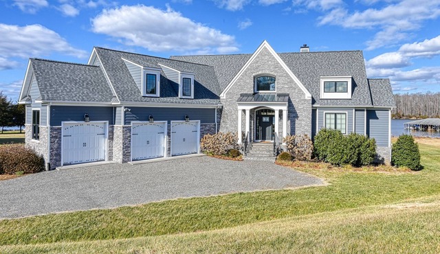 Elegant lakefront home with water access, hot tub, dock, rec room & fireplaces