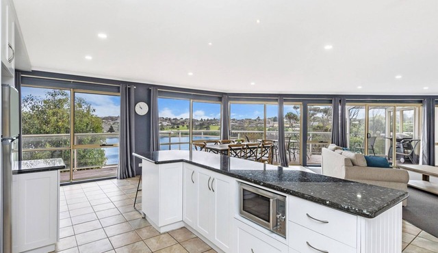Elevated waterfront home, featuring both river and ocean views.