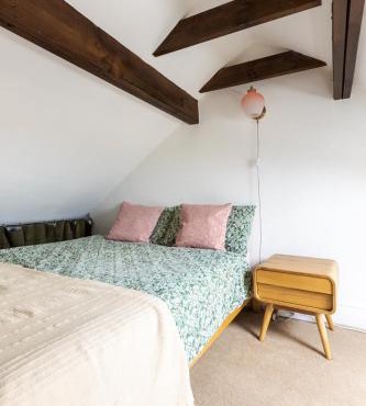 En-suite with double bed on mezzanine and desk in family home