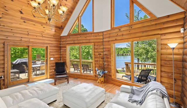 Enchanting 5-Bed/5-Bath Lakefront Log Cabin with Private Cove and Sandy Beach.