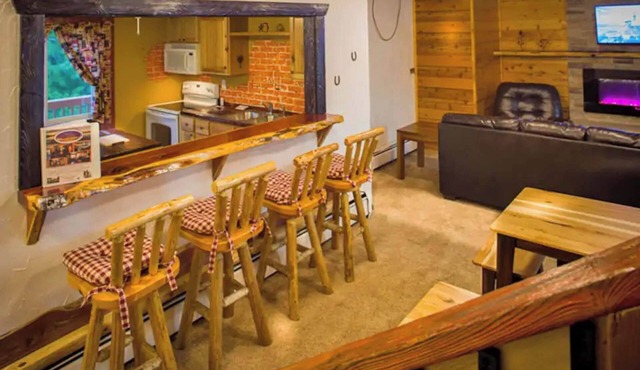 Enjoy a quiet stay on your own private deck by the lake in Room 21: Ponderosa-a Western Themed Chalet