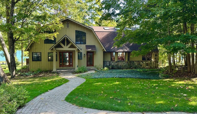 Enjoy a summer trip to this charming lake front home on beautiful Walloon Lake