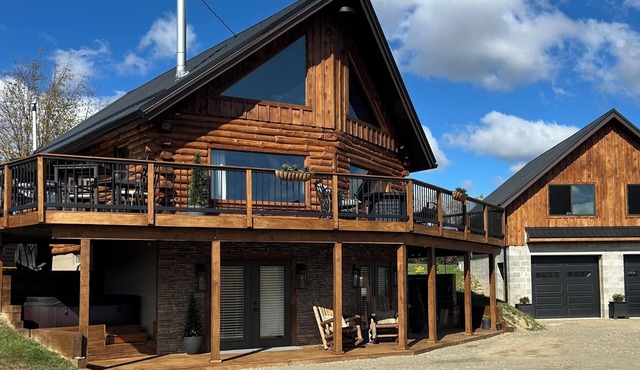 Enjoy an updated classic log cabin with ski slope views from the hot tub.