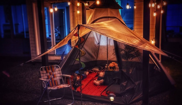 Enjoy camping in a well-maintained yard with a firepit, hot tub and a pool table