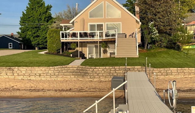 Enjoy Crystal Lake's pristine water and amazing sunsets from this lakefront home