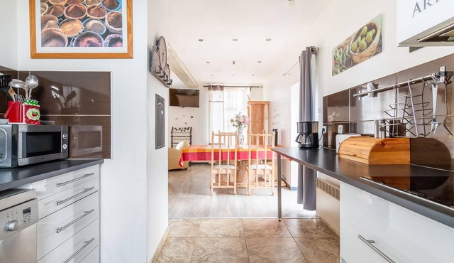 Enjoy this cozy and pretty vacation home by a stream in green surroundings.