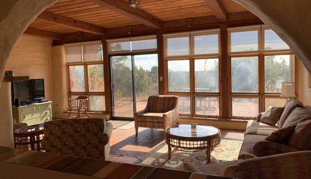 Escape a cold winter in our large passive solar adobe home with 4 gentle seasons