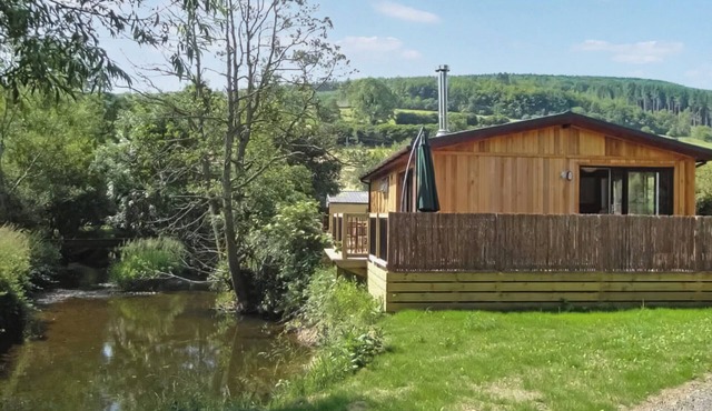 Escape to a modern riverside lodge, perfectly set by the tranquil River Clun.