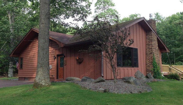 Escape to the Northwoods at this picturesque Sand Lake home