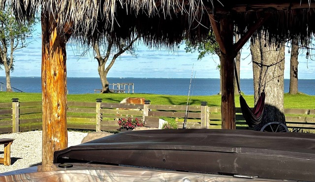 Escape to this stunning bayfront retreat in Beach City, where art meets nature!
