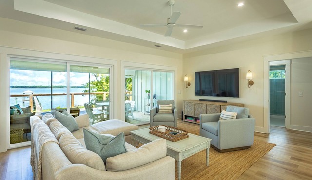 Escape to this new construction coastal getaway and soak in the beauty of waterfront living