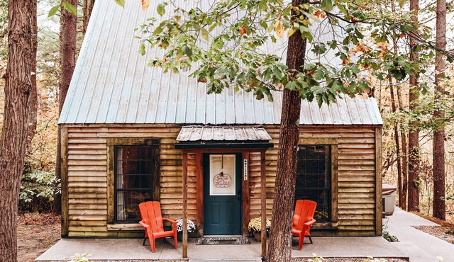 Evergreen Hideaway is a cabin nestled under tall pines.