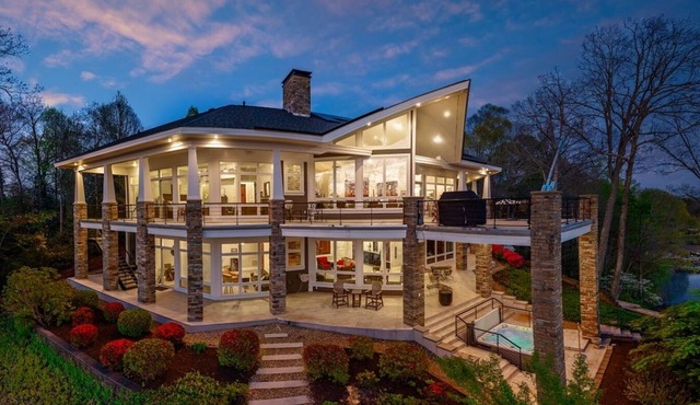 Exclusive 2-acre private island estate on Lake Norman. 7 bedrooms, sleeps 22. Panoramic lake views, lakefront hot tub, game rooms, chef's kitchen & private dock. Your own island for unforgettable group getaways.